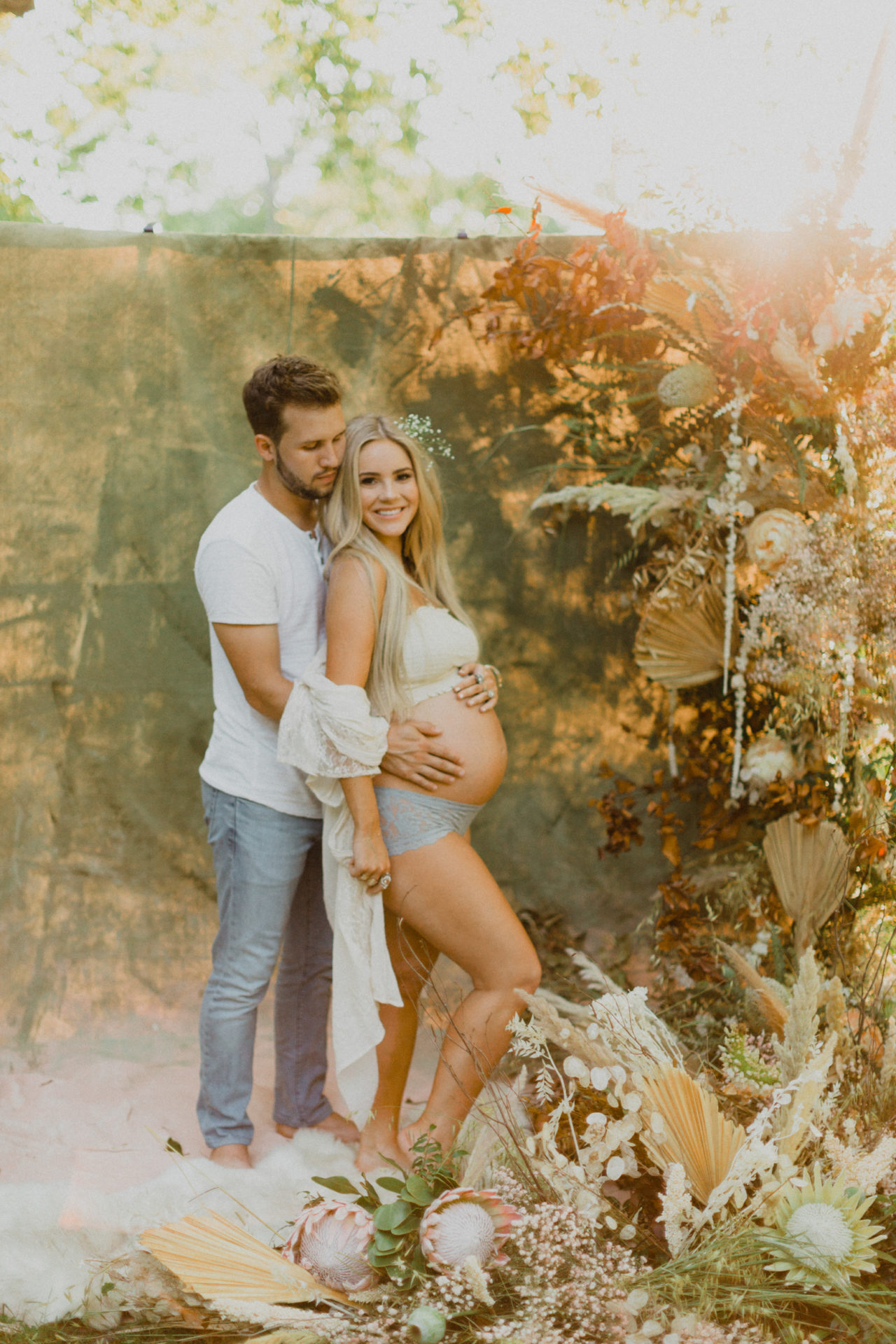 boudoir outdoor maternity photoshoot with wildflowers