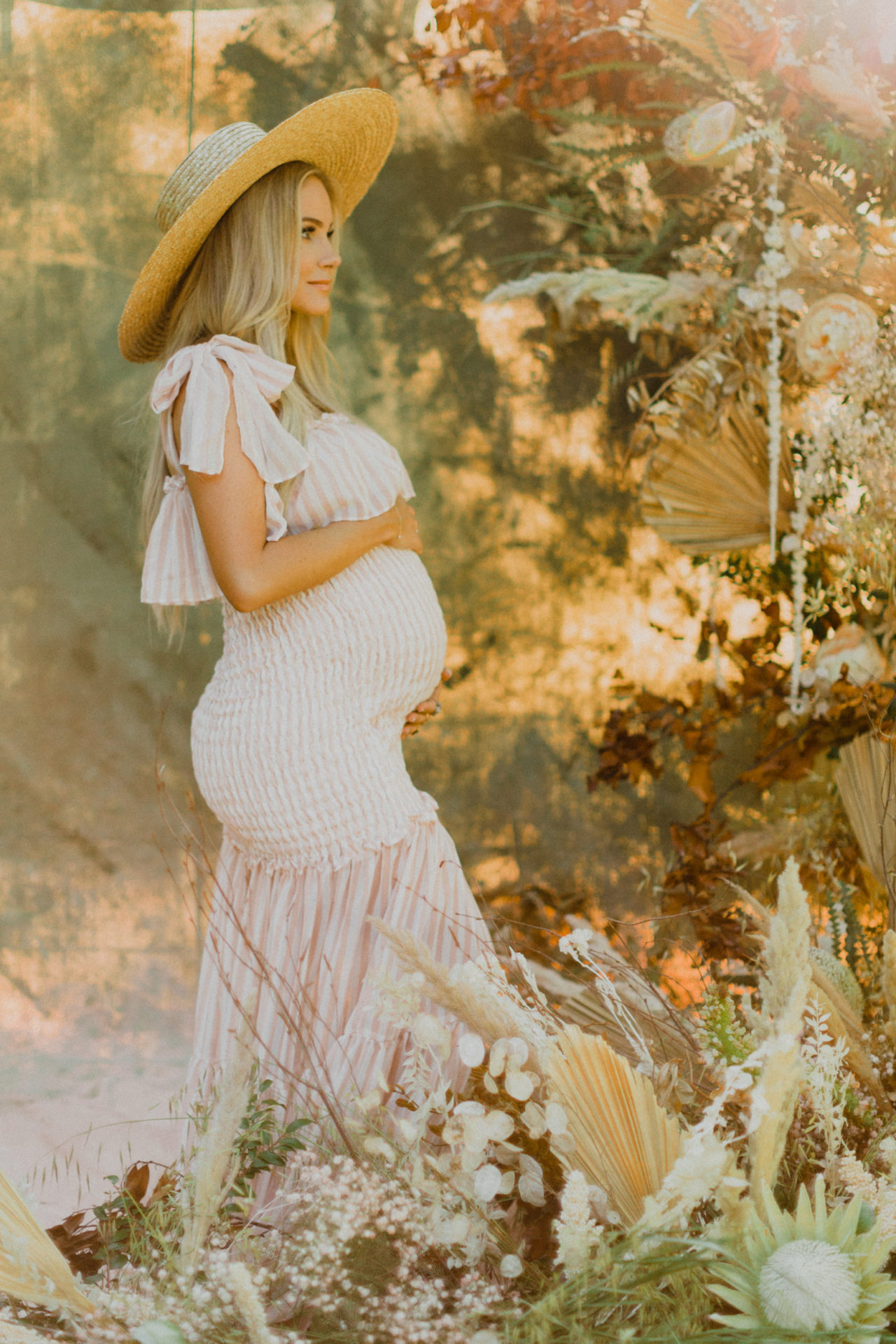 Wild flower maternity shoot with sun hat