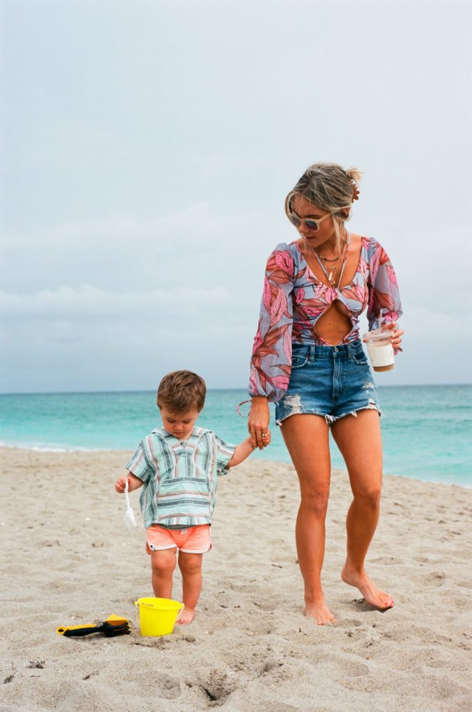 mom and toddler playing on the beach